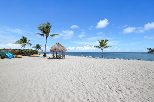 water view with a gazebo and a beach view