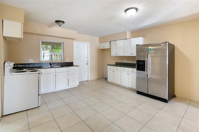 kitchen with white electric range oven, stainless steel refrigerator with ice dispenser, white cabinets, and sink