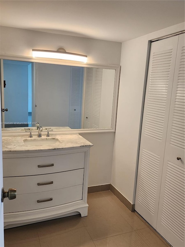 bathroom featuring tile patterned flooring and vanity