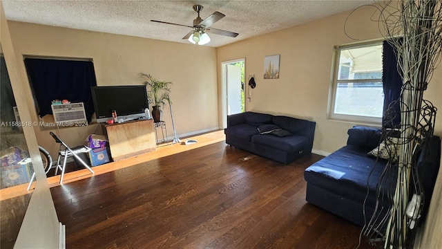 living room featuring a textured ceiling, hardwood / wood-style flooring, and ceiling fan