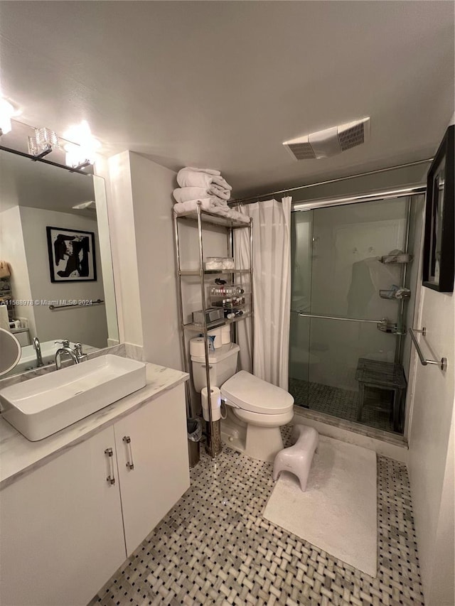 full bathroom featuring toilet, a stall shower, visible vents, and vanity