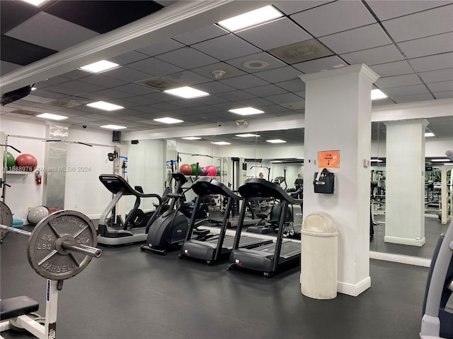 workout area with baseboards and a drop ceiling