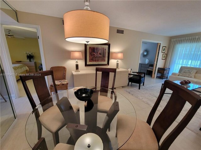 dining area featuring light tile floors