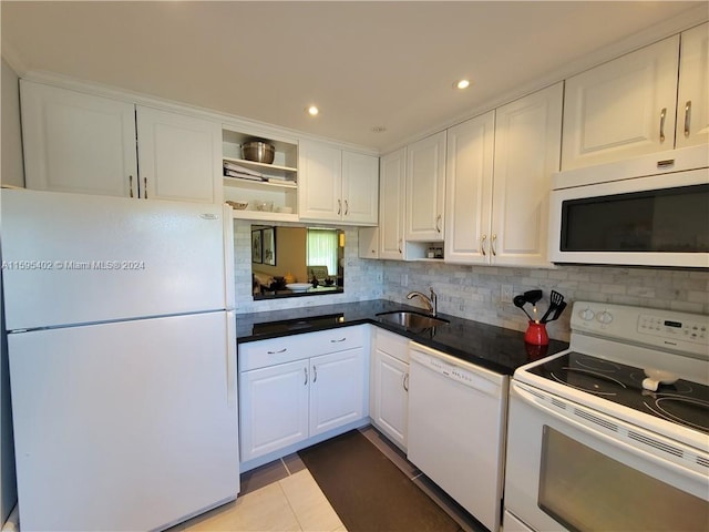 kitchen featuring white appliances, white cabinets, dark countertops, open shelves, and a sink