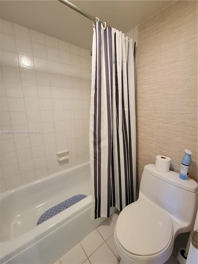 bathroom featuring shower / bath combo with shower curtain, tile flooring, and toilet