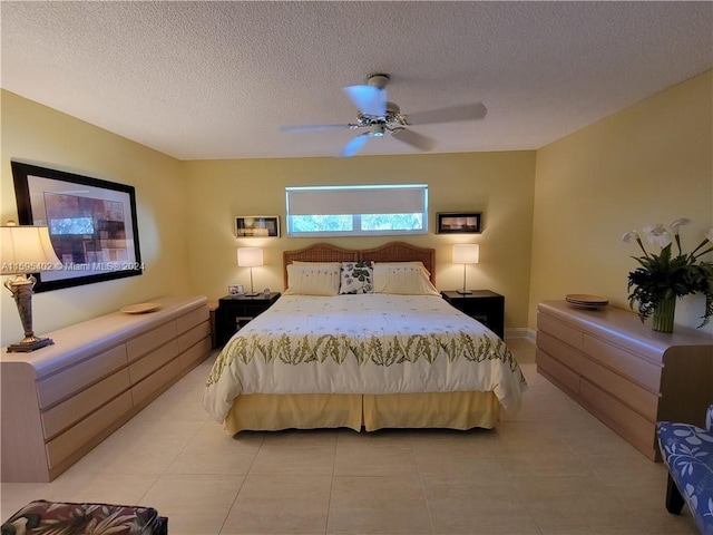 bedroom with ceiling fan, a textured ceiling, and light tile floors