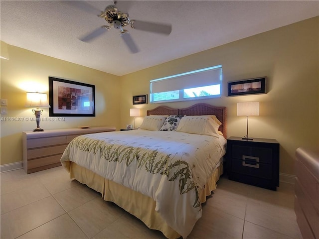 bedroom with light tile patterned floors, ceiling fan, and baseboards