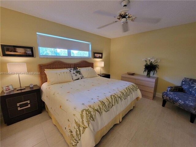 bedroom featuring ceiling fan and light tile floors