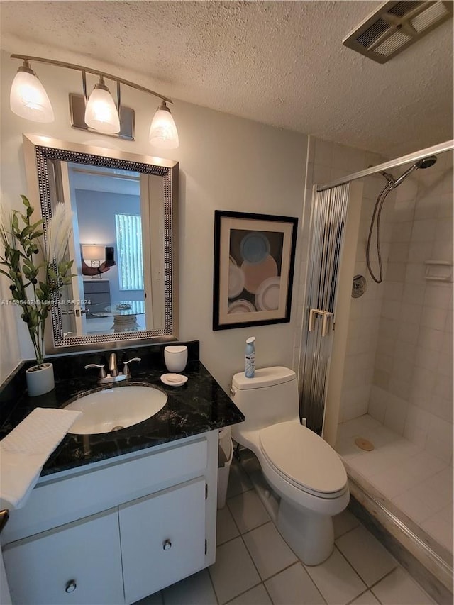 full bath featuring a textured ceiling, a stall shower, vanity, and visible vents