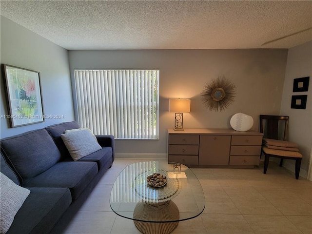 tiled living room featuring a textured ceiling