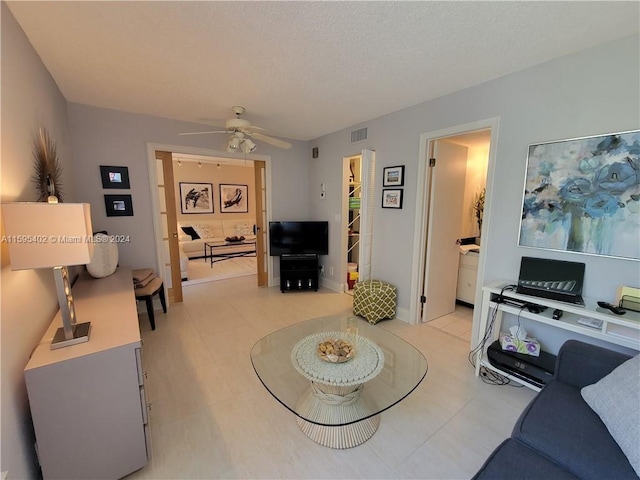 living room with ceiling fan and light tile flooring