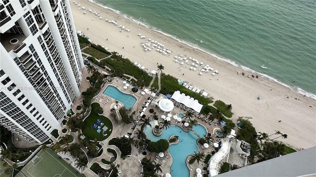 drone / aerial view featuring a water view and a beach view