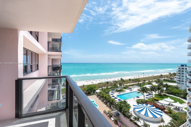 balcony featuring a water view and a view of the beach