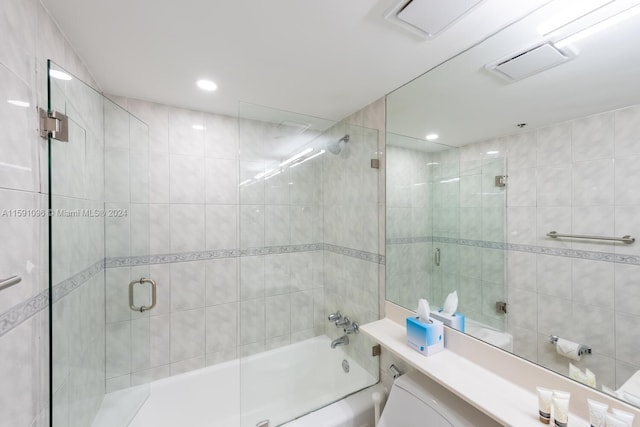 bathroom with combined bath / shower with glass door and vanity