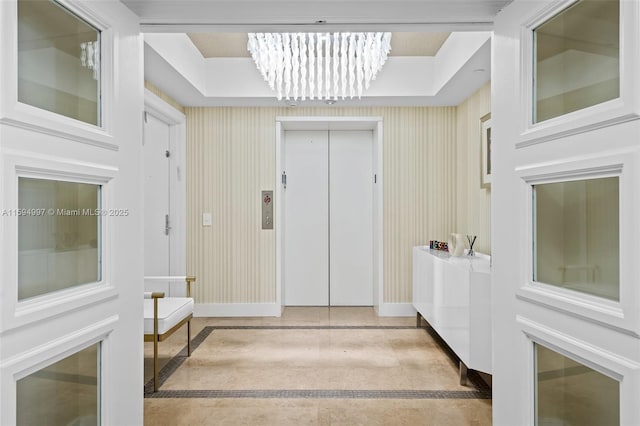 interior space featuring elevator and an inviting chandelier