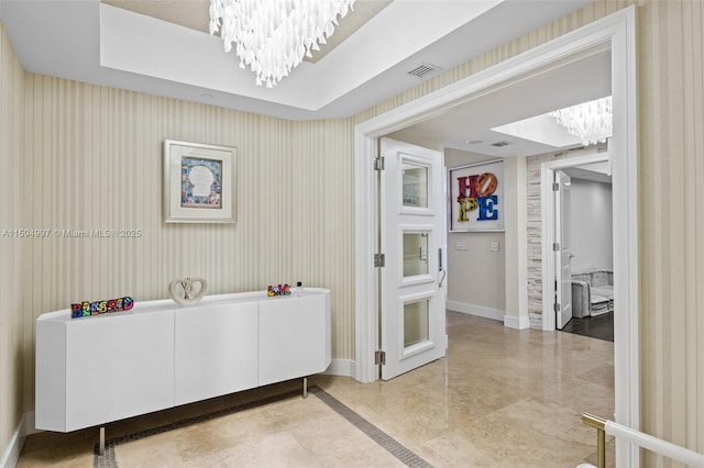 bathroom featuring a tray ceiling, tile patterned floors, and a chandelier