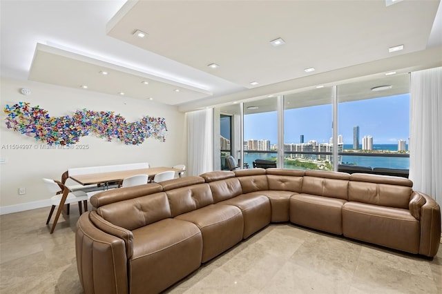 living room with floor to ceiling windows and a water view