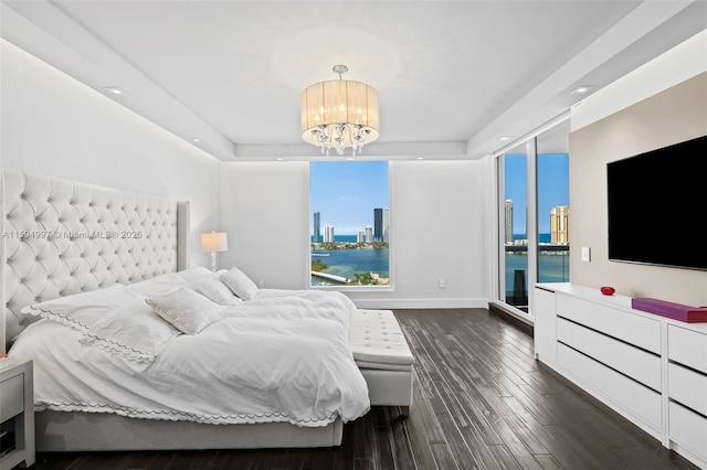 bedroom with dark hardwood / wood-style flooring and an inviting chandelier