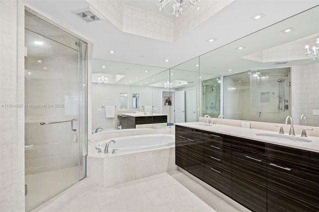 bathroom featuring a notable chandelier, vanity, shower with separate bathtub, and tile patterned floors