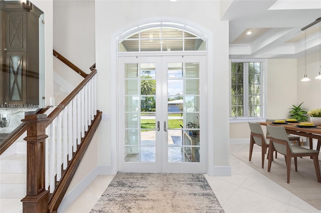 foyer with french doors and light tile patterned flooring