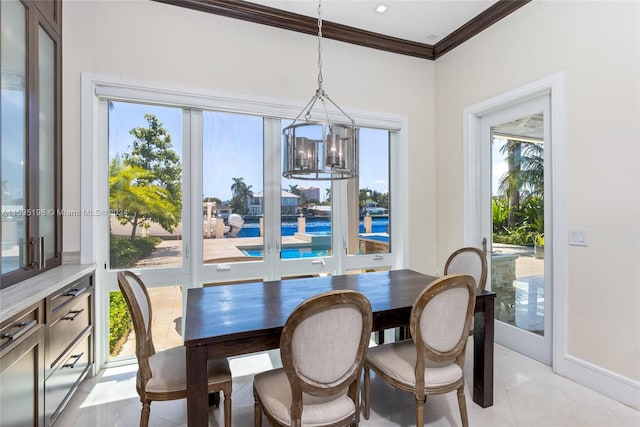 tiled dining area featuring ornamental molding and a notable chandelier