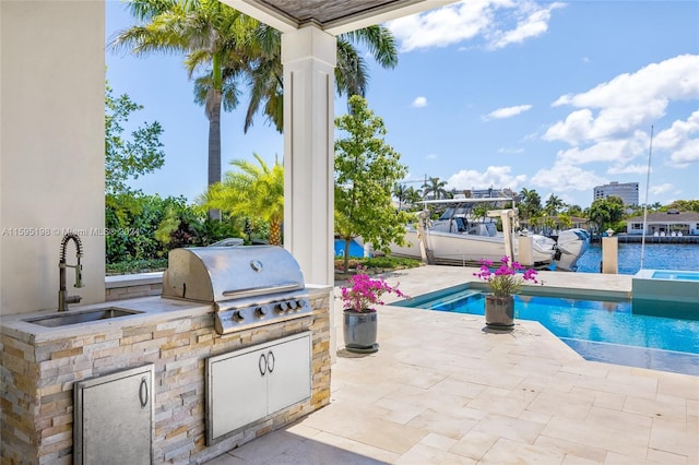 view of patio / terrace featuring grilling area, sink, and exterior kitchen