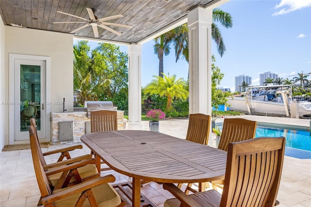 view of patio / terrace with a grill, ceiling fan, and exterior kitchen