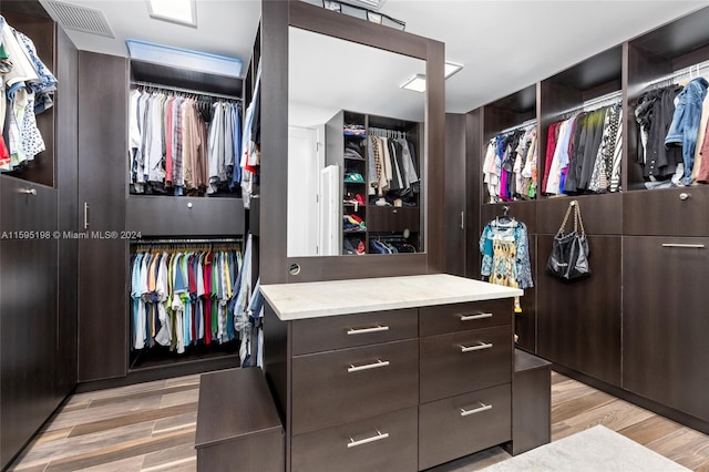 spacious closet with light hardwood / wood-style floors