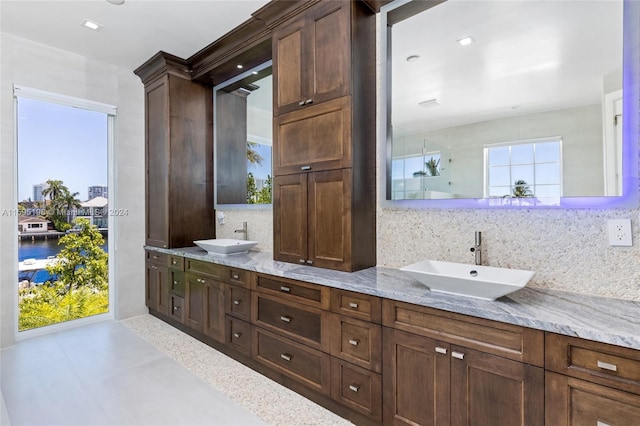 bathroom featuring vanity and tasteful backsplash