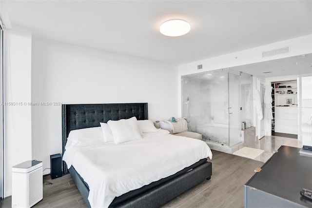 bedroom with wood-type flooring