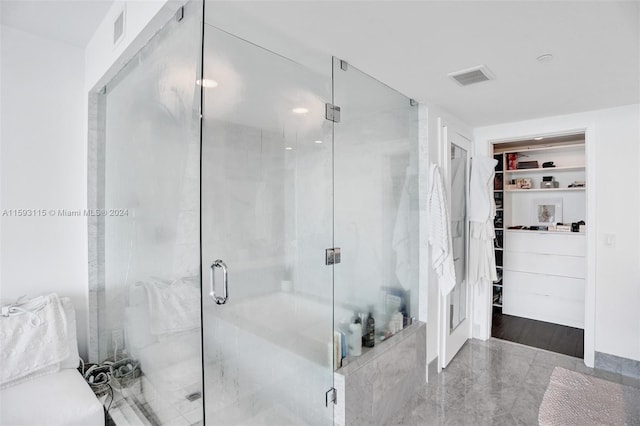 bathroom with a shower with door