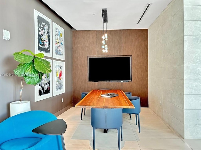 home office with wooden walls and light tile patterned flooring