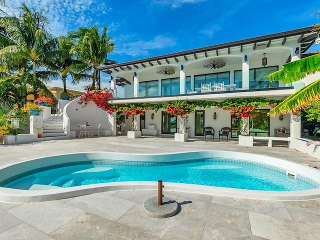 view of swimming pool featuring a patio area and ceiling fan