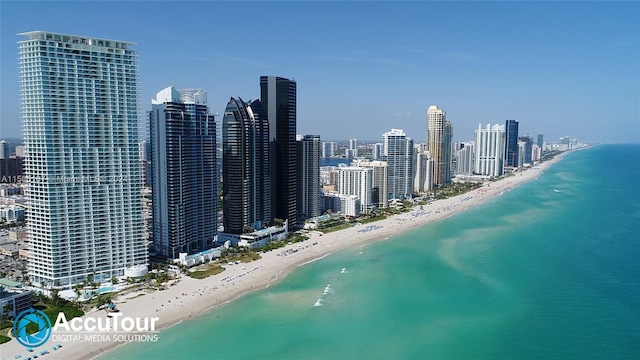 drone / aerial view featuring a water view and a beach view