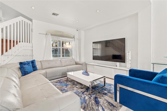 living room featuring visible vents, recessed lighting, and stairs