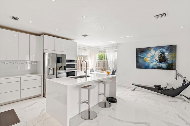 kitchen with visible vents, modern cabinets, marble finish floor, and a sink