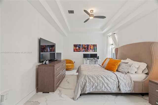 bedroom featuring a raised ceiling, visible vents, marble finish floor, and a ceiling fan