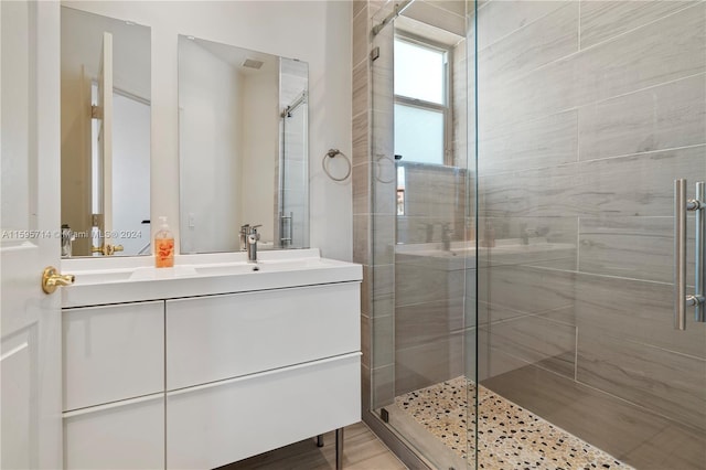 full bathroom featuring vanity and a stall shower
