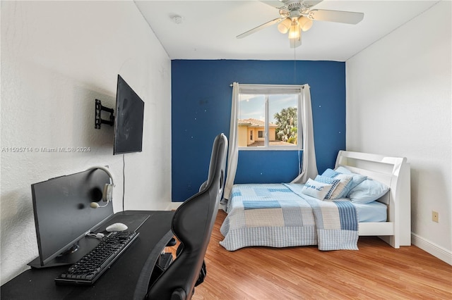 bedroom with baseboards, wood finished floors, and ceiling fan