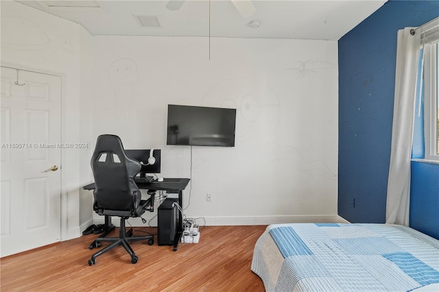 bedroom featuring visible vents, baseboards, and wood finished floors