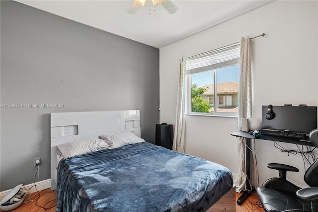 bedroom featuring baseboards, a ceiling fan, and wood finished floors