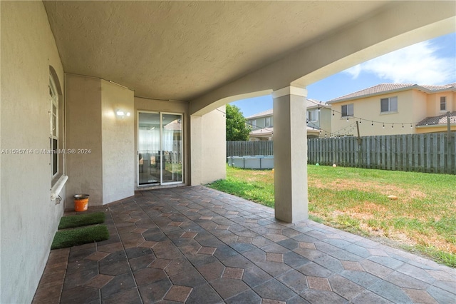 view of patio / terrace featuring fence and a residential view