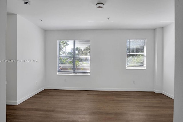 empty room featuring dark wood-type flooring