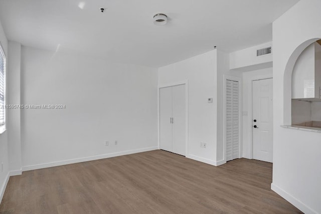 spare room featuring hardwood / wood-style floors