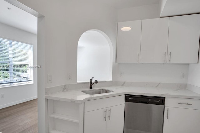 kitchen featuring white cabinetry, sink, light wood-type flooring, and stainless steel dishwasher