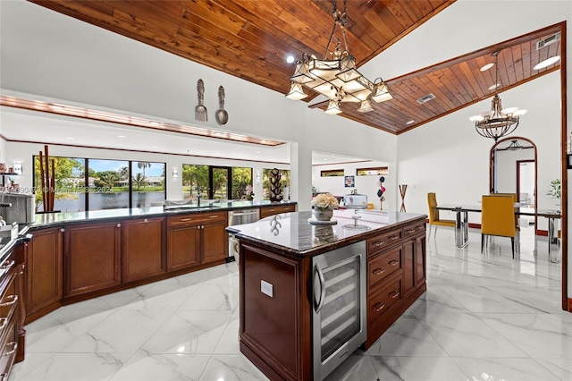 kitchen with wood ceiling, a center island, vaulted ceiling, beverage cooler, and a water view