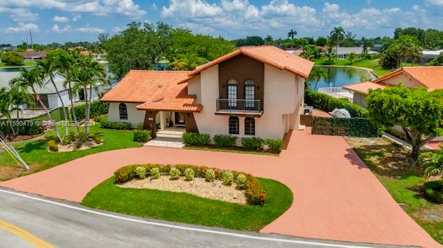 mediterranean / spanish home featuring a water view and a balcony