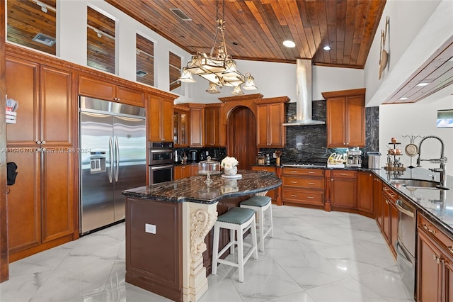 kitchen featuring wall chimney range hood, wood ceiling, appliances with stainless steel finishes, high vaulted ceiling, and sink