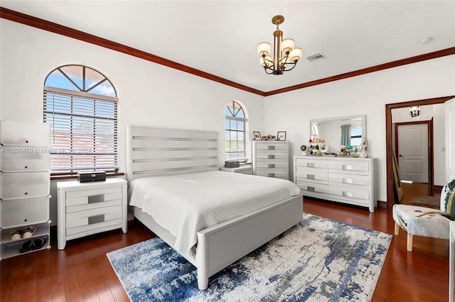 bedroom featuring dark wood-type flooring, crown molding, a notable chandelier, and multiple windows