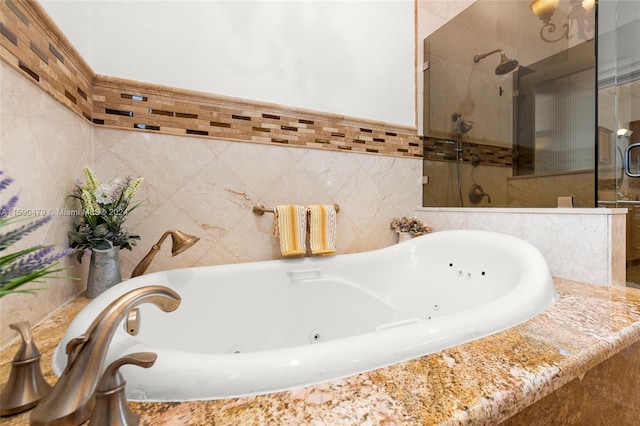 bathroom featuring shower with separate bathtub